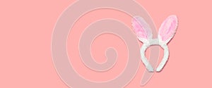 Sweet fluffy bunny ears isolated on pink background, top view, blank copy space for advertising text