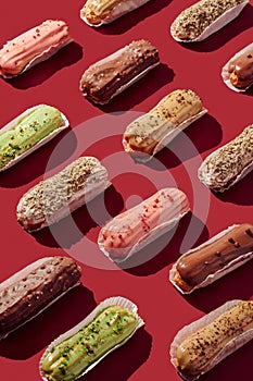 Sweet food pattern of eclairs with color topping. Sweet shacks, minimalism