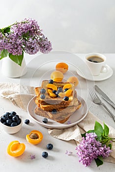 Sweet french toast with berries and syrup served on plate. Copy space for text. Healthy breakfast: toasts with blueberry and