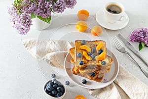 Sweet french toast with berries and syrup served on plate. Copy space for text. Healthy breakfast: toasts with blueberry and