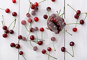 Sweet fresh cherries on white wood background