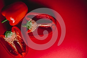 SWEET, fresh RED PEPPER ON A RED BACKGROUND, cut in half. photo for the menu, proper nutrition. fresh vegetables