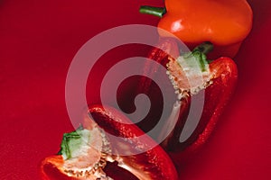 SWEET, fresh RED PEPPER ON A RED BACKGROUND, cut in half, thick smoke around. photo for the menu, proper nutrition