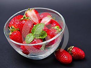 Sweet fresh strawberries in bowl on a gray background. Food concept.