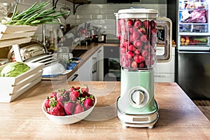 Sweet fresh strawberry cocktail in vintage retro blender on the kitchen table