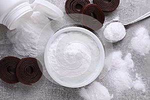 Sweet fructose powder and fruit leather rolls on light grey table, flat lay