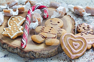 Sweet gifts for holiydays. Homemade christmas gingerbread cookies and caramel candies on wooden board, horizontal