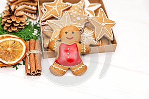 Sweet gingerbread cookie man and box of christmas cookies. Baking