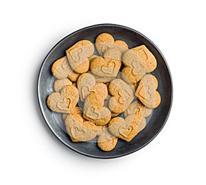 Sweet gingerbread hearts on plate isolated on white background