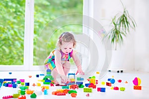 Sweet girl playing with blocks