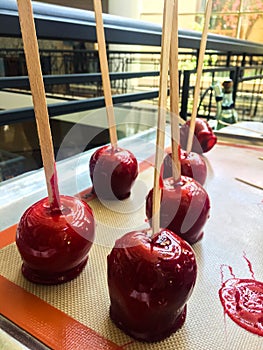 Sweet glazed red toffee candy apples on sticks