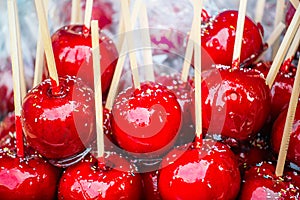 Sweet glazed red toffee candy apples on sticks