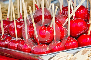 Sweet glazed red toffee candy apples on sticks