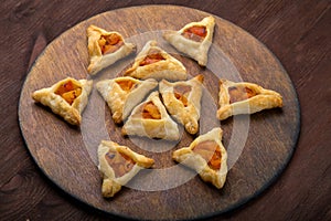 Sweet gomentashi cookies for the Jewish holiday of Purim on a chalkboard are laid out in the form of Magen David on the