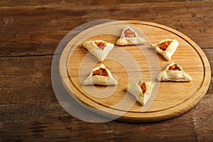 Sweet gometashi cookies for Purim laid out on a chalkboard in the shape of magen David. copy space