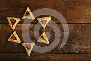 Sweet gometashi cookies for Purim laid out on a wooden table in the form of Magen David.copy space