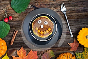 Sweet Halloween food, pumpkin pancakes for kids