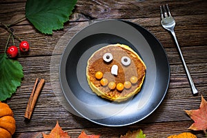 Sweet Halloween food, pumpkin pancakes for kids