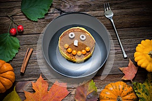Sweet Halloween food, pumpkin pancakes for kids