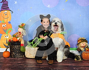 Sweet Halloween photo of little girl and her puppy