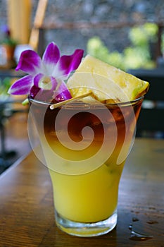 Sweet Hawaiian Mai Tai cocktail with an orchid flower