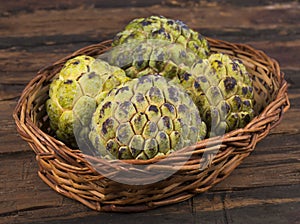 Sweet And Healthy Fruit Custard Apple on Wooden Table photo