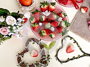 Sweet hearts Strawberry  and slices  on white background ,table setting ,flowers in red cup ,and ,branch in heart shape still life