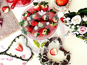 Sweet hearts Strawberry  and slices  on white background ,table setting ,flowers in red cup ,and ,branch in heart shape still life