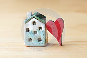 Sweet home concept, mini house symbol and red heart