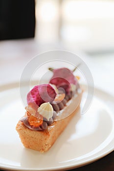 Sweet homemade fance peach cake on wooden table