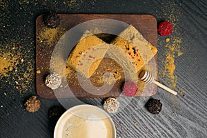 Sweet homemade honey cake and truffeles with coffee in porcelain cup