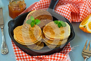 Sweet homemade mini pancakes with maple syrup