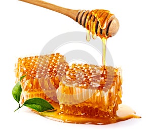 Sweet honeycomb and wooden Honey dripping isolated on a white background. Honey dipper