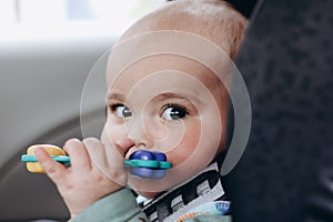 Sweet infant in the car sits in a child seat. Safe driving. Baby care