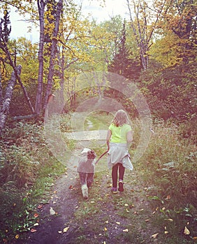 Sweet instagram of young girl walking her dog in the forest