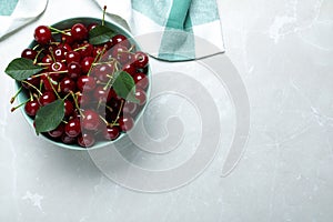 Sweet juicy cherries on light marble table. Space for text