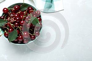 Sweet juicy cherries on light marble table. Space for text