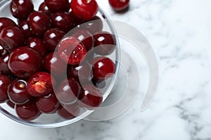 Sweet juicy cherries on white marble table, top view. Space for text