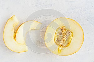 sweet juicy melon on white textured background. flat lay of half a melon and two slices.. The concept of healthy sweets.