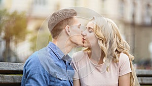Sweet kiss of beautiful young couple in love, happy people enjoying romance