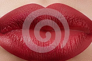 Sweet kiss. Close-up of woman's lips with fashion red make-up. Beautiful female mouth, full lips with perfect makeup