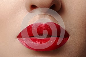 Sweet kiss. Close-up of woman's lips with fashion red make-up. Beautiful female mouth, full lips with perfect makeup