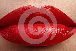 Sweet kiss. Close-up of woman's lips with fashion red make-up. Beautiful female mouth, full lips with perfect makeup