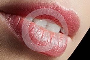 Sweet kiss. Perfect natural lip makeup. Close up macro photo with beautiful female mouth. Plump full lips