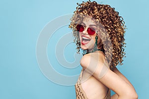 Sweet lady disco on an isolated blue background, red sunglasses