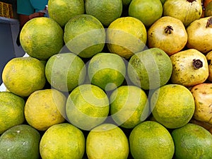 Sweet lemon orange fruits in the market on fruit stall for selling.