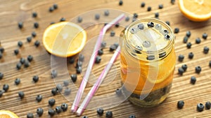 Sweet lemonade with orange and blueberry in a jar