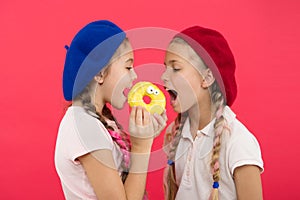 Sweet life. Sweets shop and bakery concept. Kids fans of baked donuts. Share sweet donut. Girls in beret hats hold donut