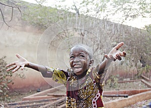 Sweet little African boy under the rain in Mali Africa