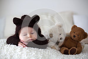 Sweet little baby boy, dressed in handmade knitted brown soft te